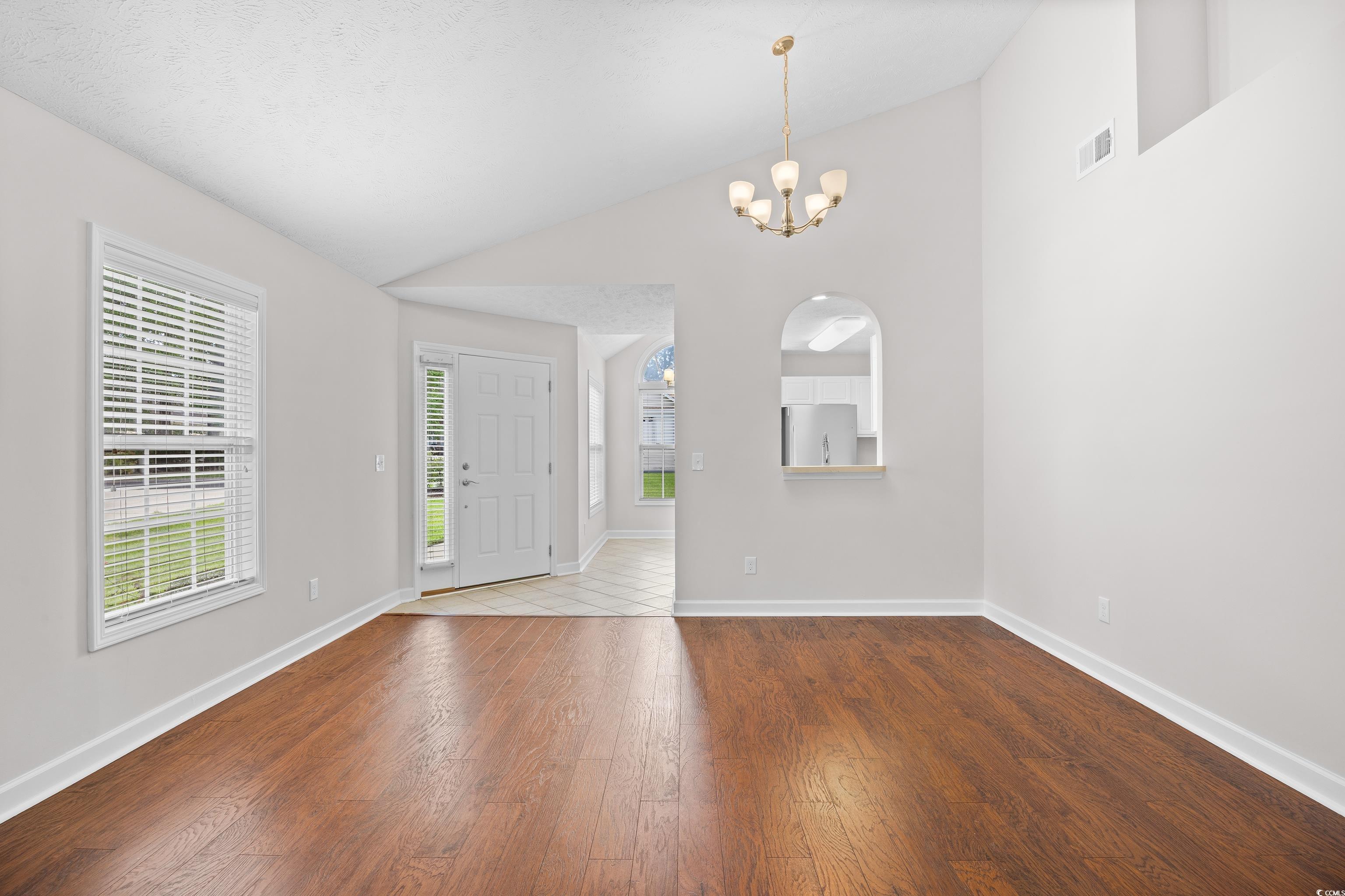 596 Oakmont Drive Myrtle Beach, SC 29579 - Photo 14 of 40 Foyer featuring lofted ceiling, wood finished floors, and a chandelier