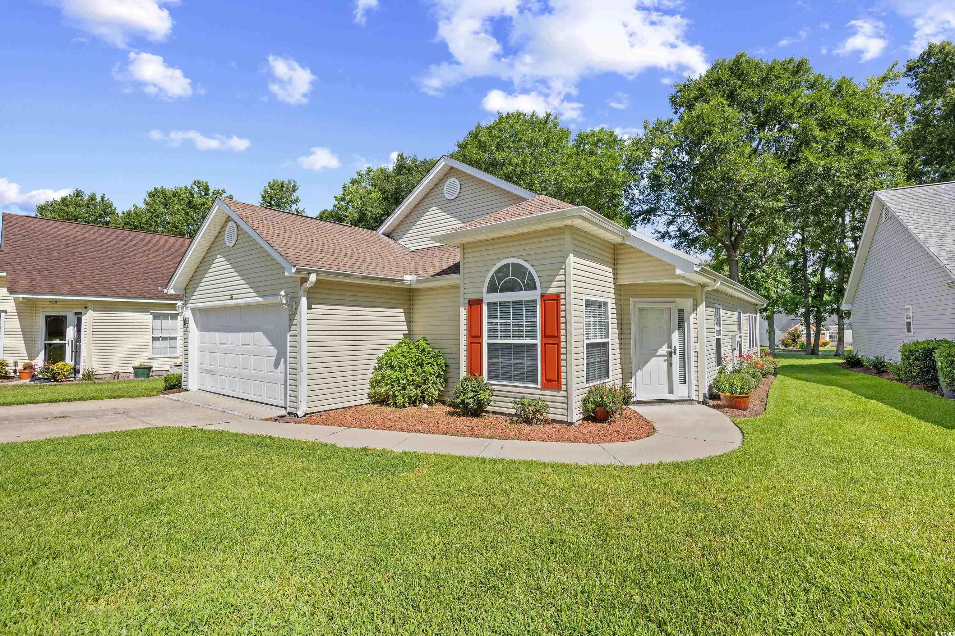 596 Oakmont Drive Myrtle Beach, SC 29579 - Photo 2 of 40 View of front of property featuring a garage, concrete driveway, a front lawn, and a shingled roof