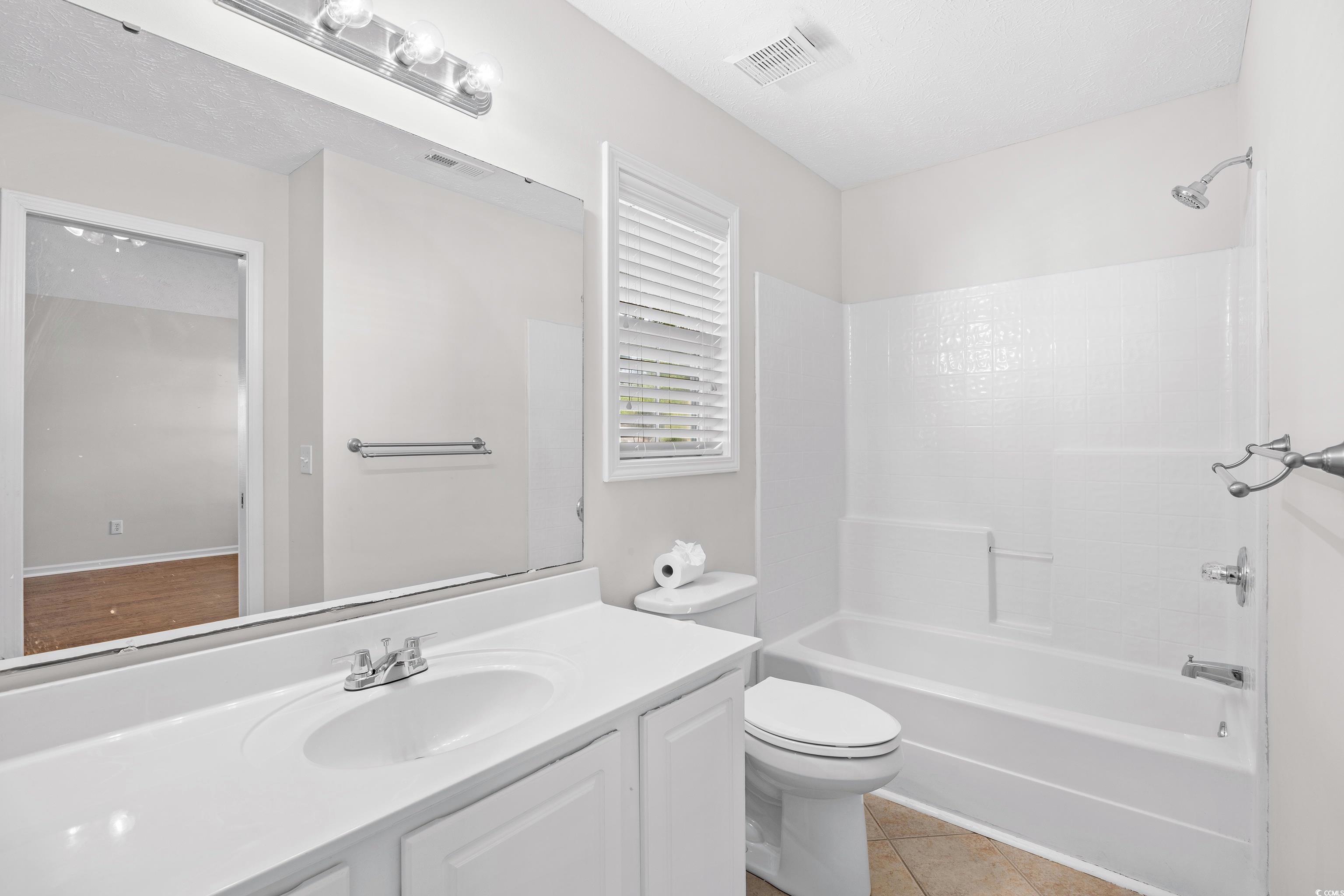 596 Oakmont Drive Myrtle Beach, SC 29579 - Photo 22 of 40 Bathroom with vanity, shower / washtub combination, and tile patterned floors