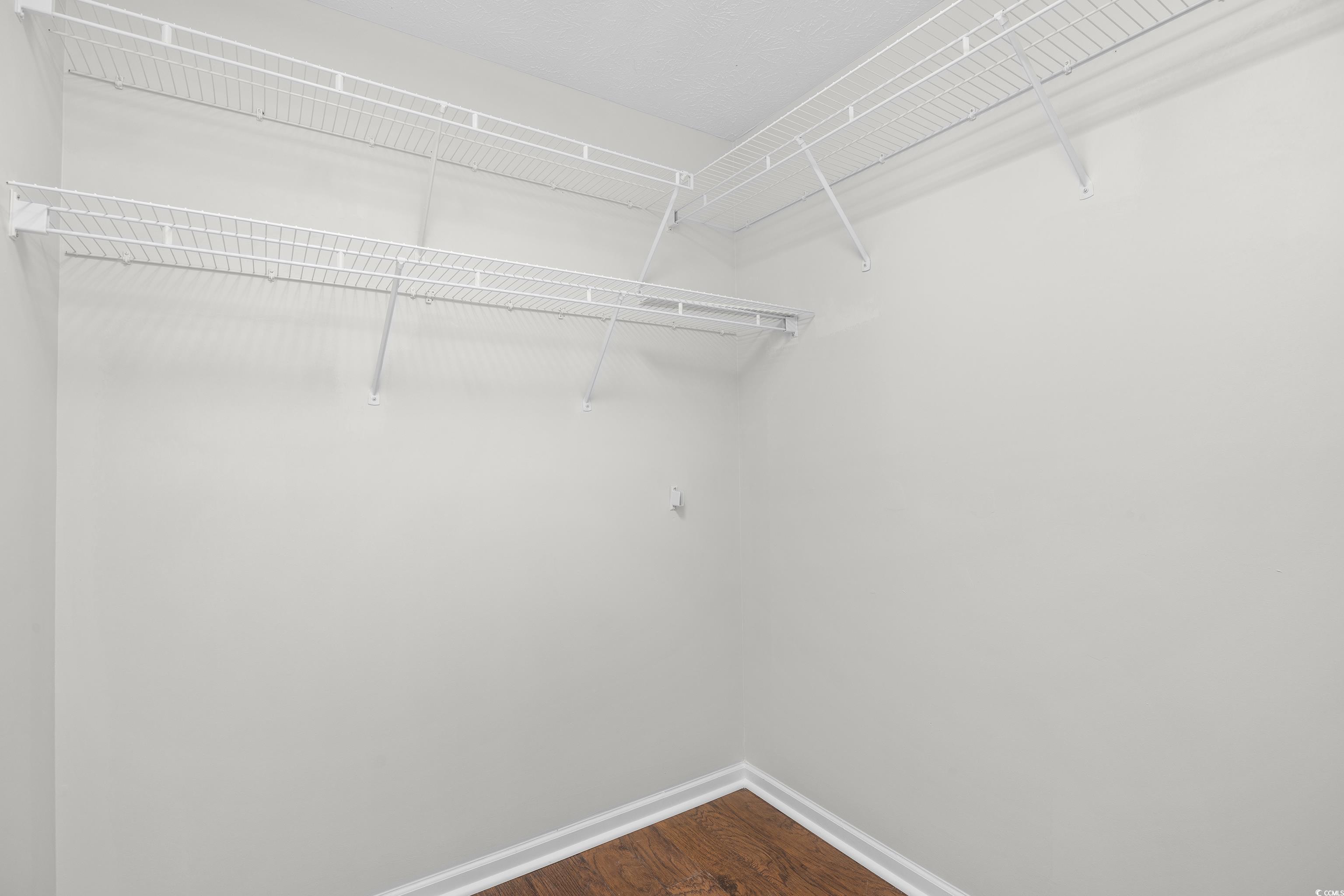 596 Oakmont Drive Myrtle Beach, SC 29579 - Photo 23 of 40 Walk in closet featuring dark wood-style flooring