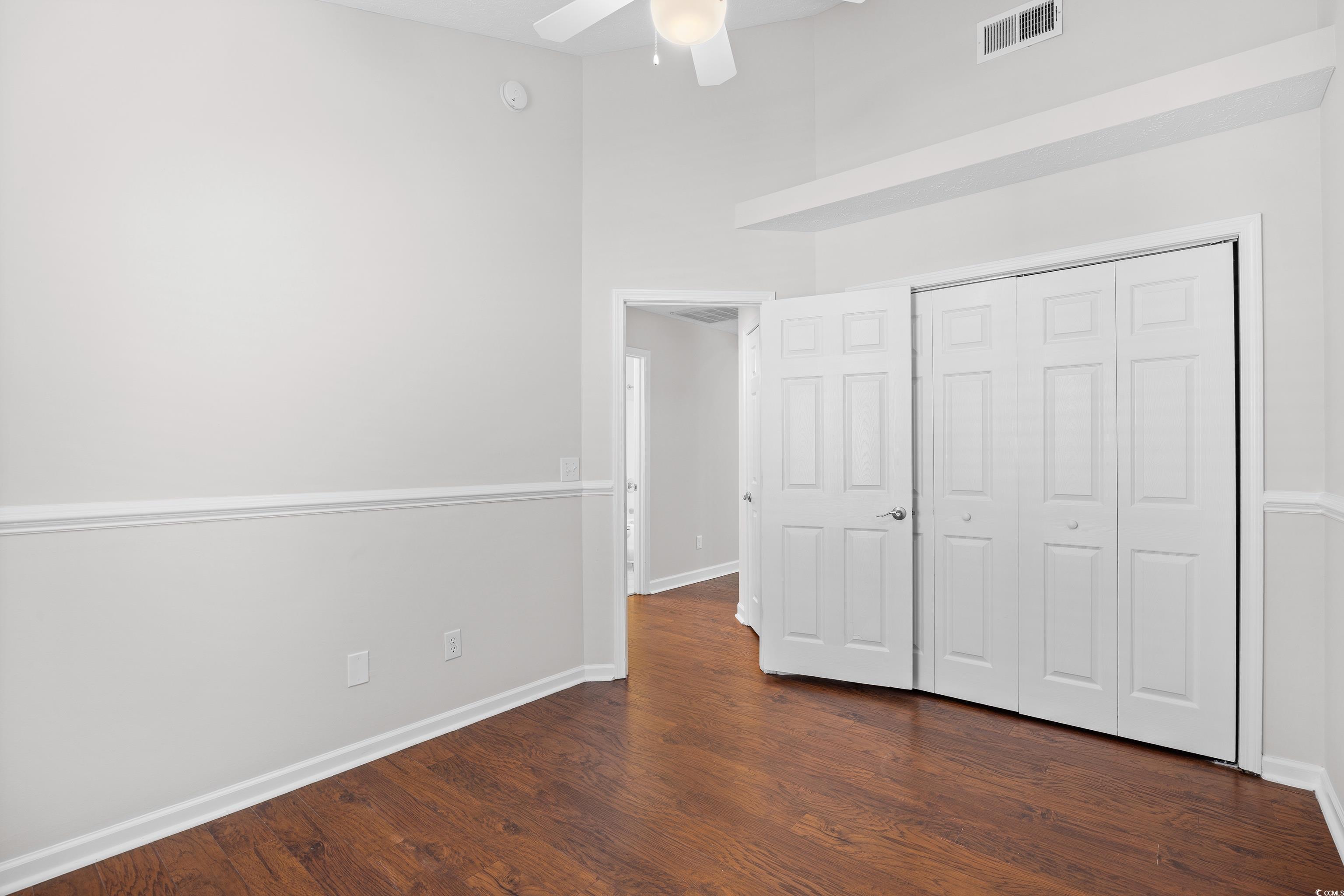 596 Oakmont Drive Myrtle Beach, SC 29579 - Photo 25 of 40 Unfurnished bedroom featuring dark wood-type flooring, a closet, and ceiling fan
