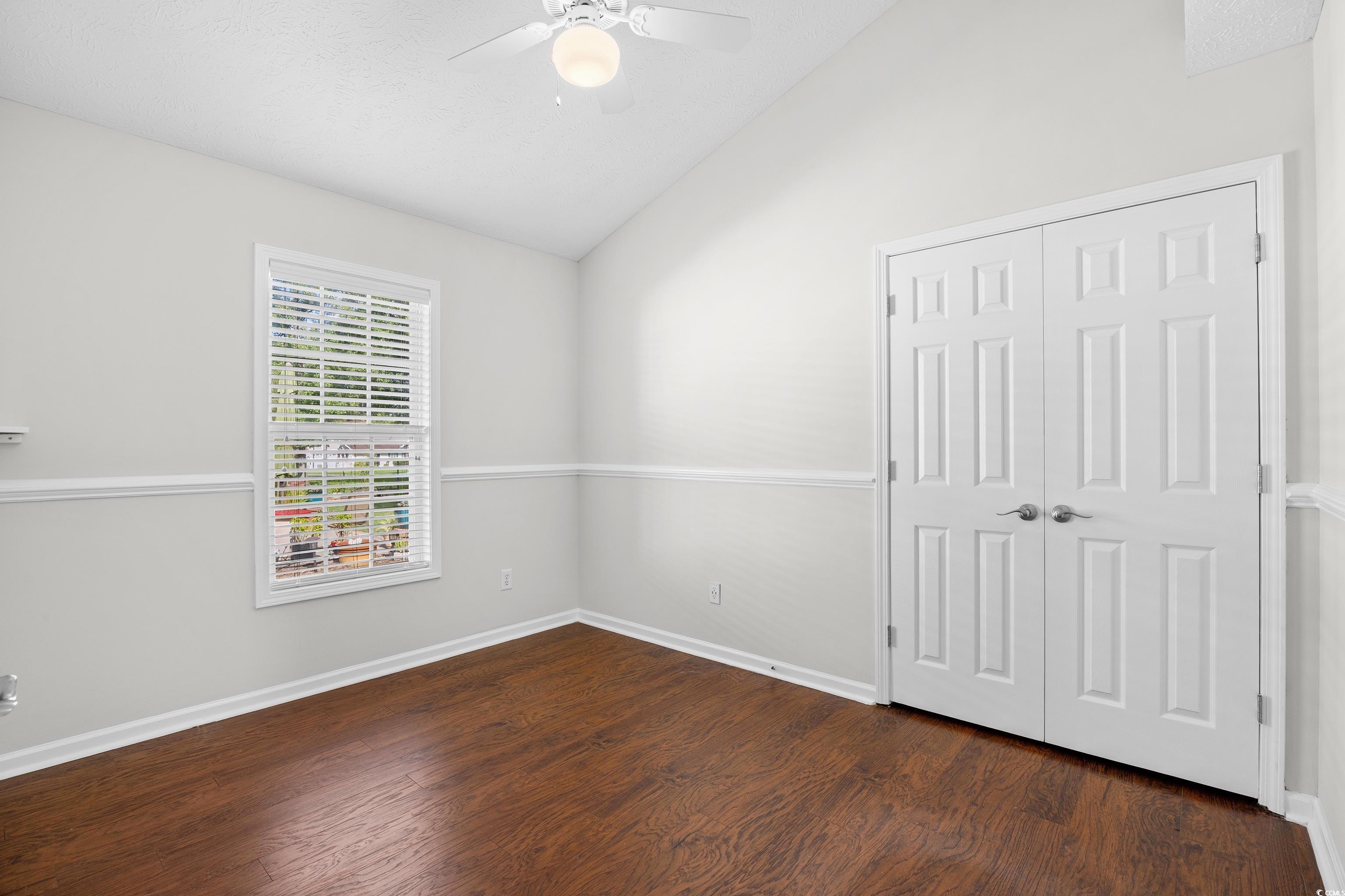 596 Oakmont Drive Myrtle Beach, SC 29579 - Photo 26 of 40 Unfurnished bedroom featuring vaulted ceiling, wood finished floors, a closet, and ceiling fan