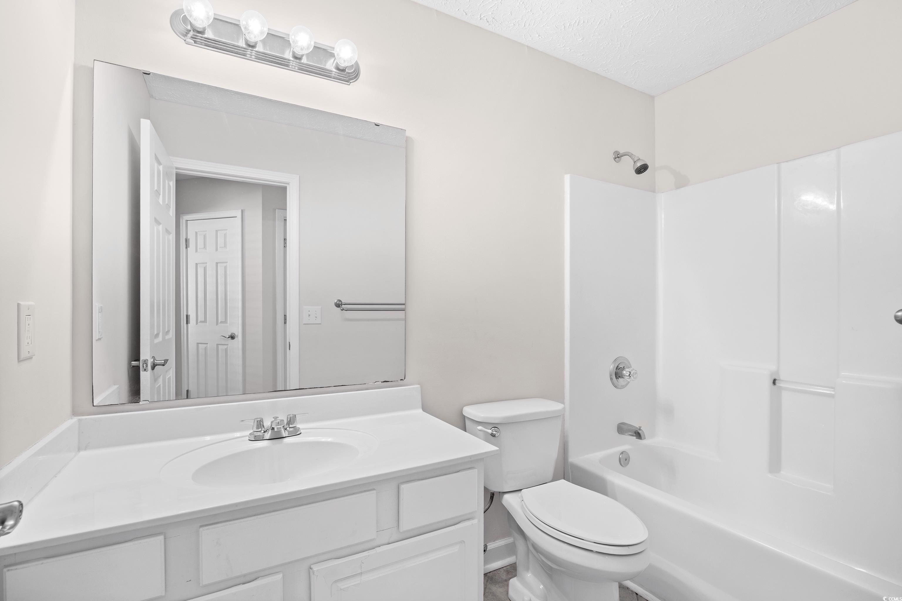 596 Oakmont Drive Myrtle Beach, SC 29579 - Photo 30 of 40 Bathroom with vanity, shower / washtub combination, and a textured ceiling