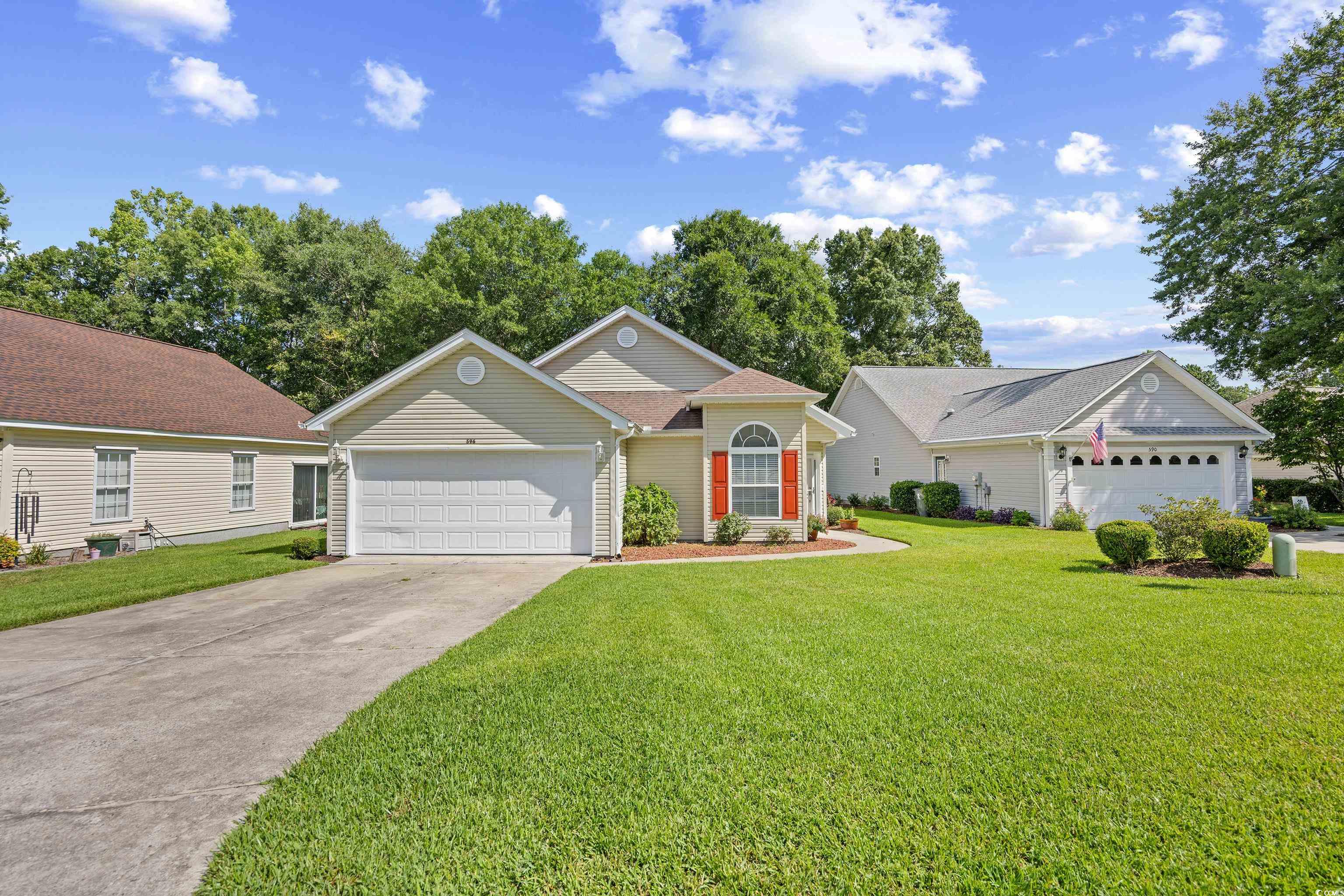 596 Oakmont Drive Myrtle Beach, SC 29579 - Photo 3 of 40 Ranch-style home with concrete driveway, an attached garage, and a front lawn