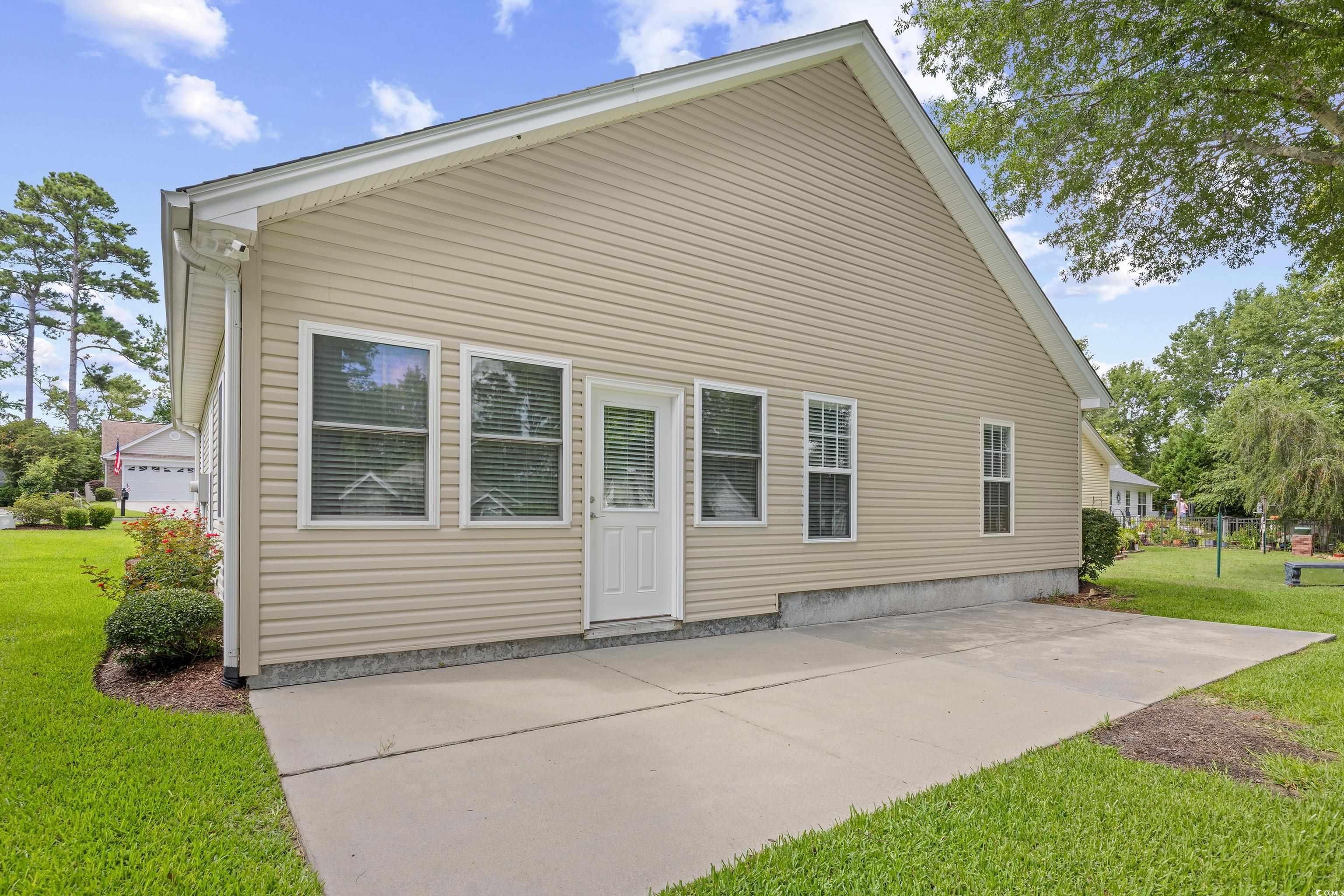 596 Oakmont Drive Myrtle Beach, SC 29579 - Photo 35 of 40 Rear view of property with a patio area and a yard