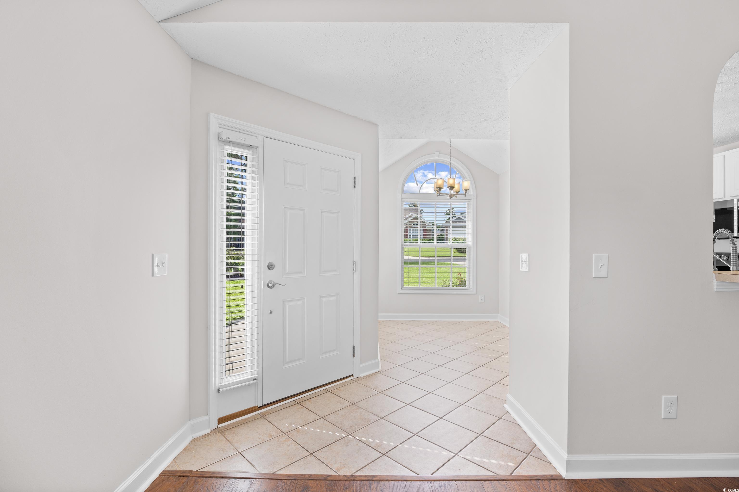 596 Oakmont Drive Myrtle Beach, SC 29579 - Photo 4 of 40 Foyer featuring a chandelier and light tile patterned floors