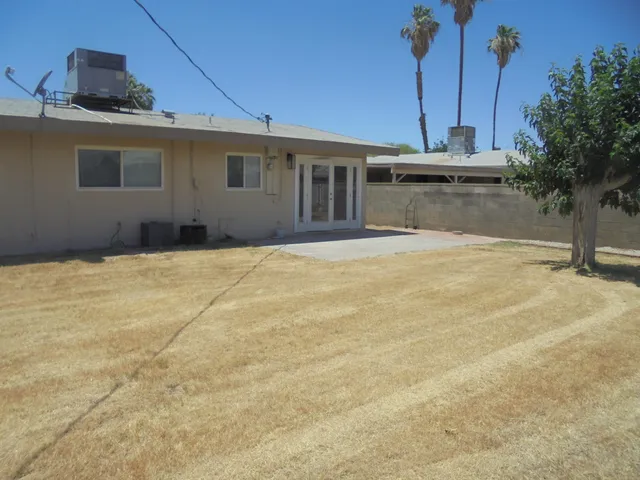 a view of a house with a backyard and a garage
