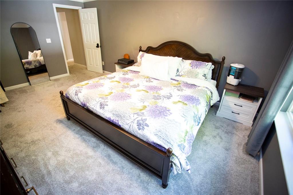 306 Old Gettysburg Way Dallas, GA 30157 - Photo 15 of 44 a large bed sitting in a bedroom next to a lamp