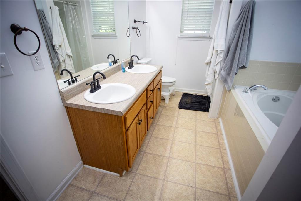 306 Old Gettysburg Way Dallas, GA 30157 - Photo 16 of 44 a bathroom with a sink a toilet and a tub