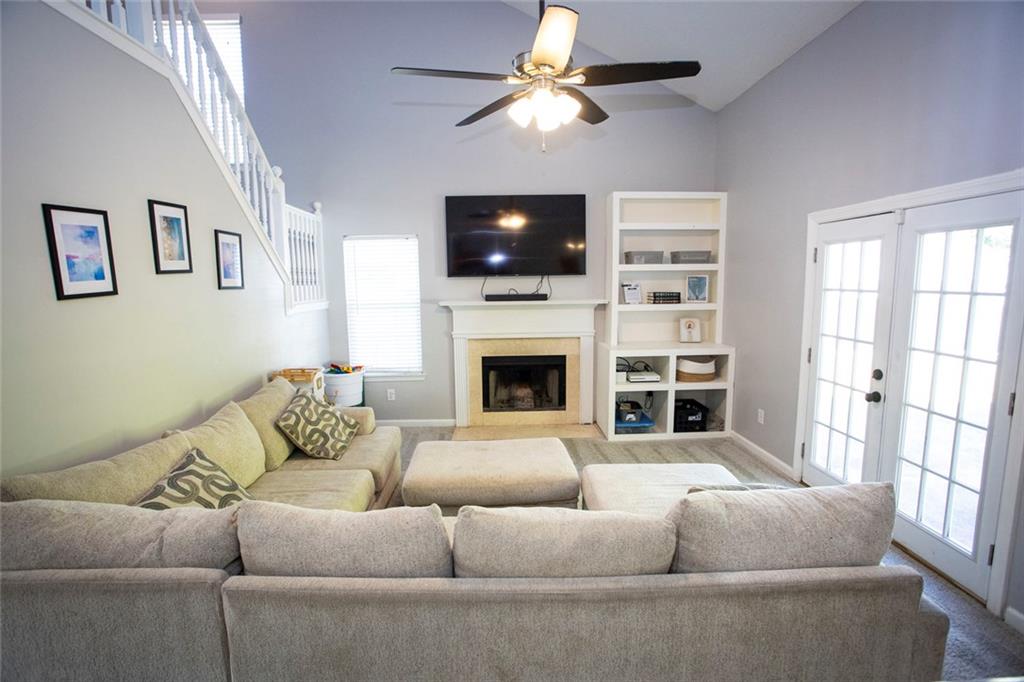 306 Old Gettysburg Way Dallas, GA 30157 - Photo 2 of 44 a living room with furniture a flat screen tv and a fireplace