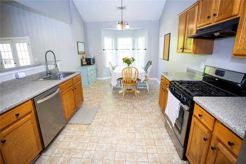 306 Old Gettysburg Way Dallas, GA 30157 - Photo 3 of 44 a kitchen with a sink stove and cabinets