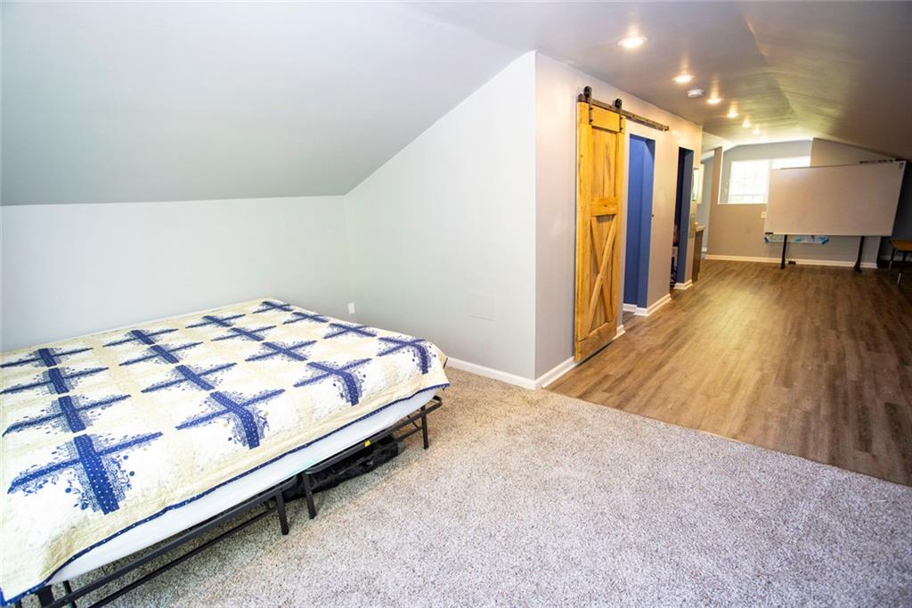 306 Old Gettysburg Way Dallas, GA 30157 - Photo 39 of 44 a bedroom with a bed and a flat screen tv