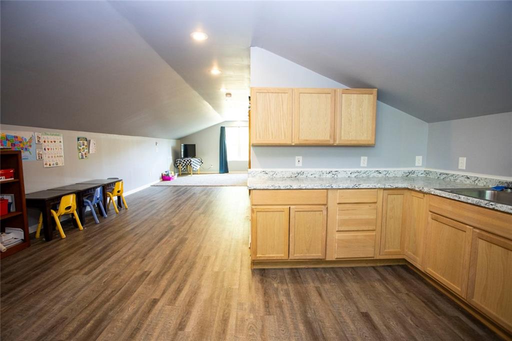 306 Old Gettysburg Way Dallas, GA 30157 - Photo 41 of 44 a kitchen with granite countertop a sink cabinets and wooden floor