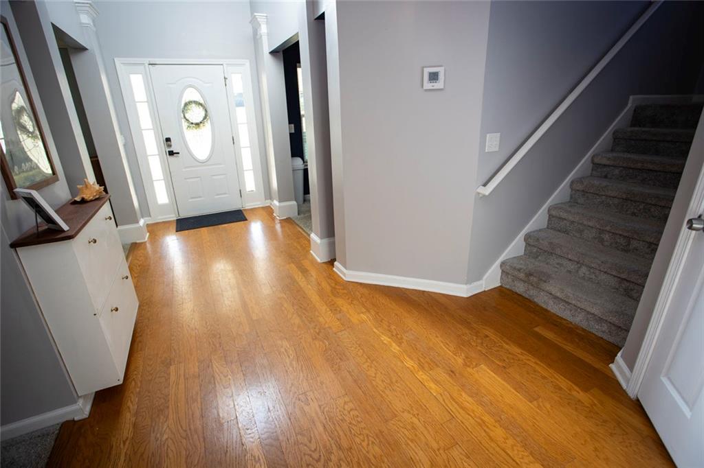 306 Old Gettysburg Way Dallas, GA 30157 - Photo 6 of 44 a view of a hallway with wooden floor and stairs