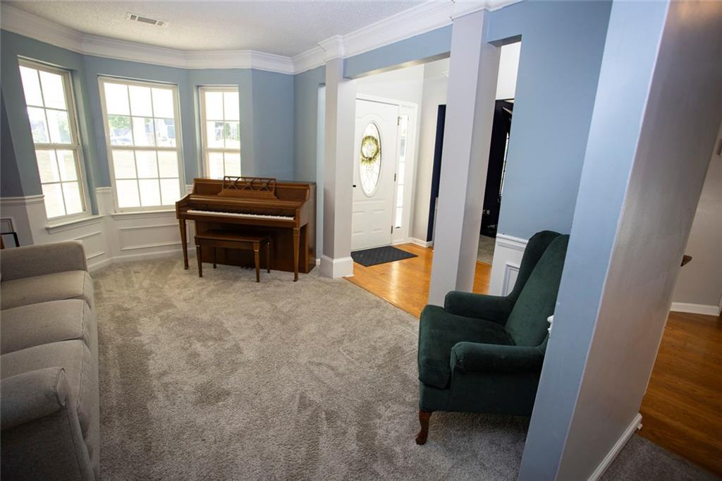 306 Old Gettysburg Way Dallas, GA 30157 - Photo 7 of 44 a living room with furniture and a piano next to a window