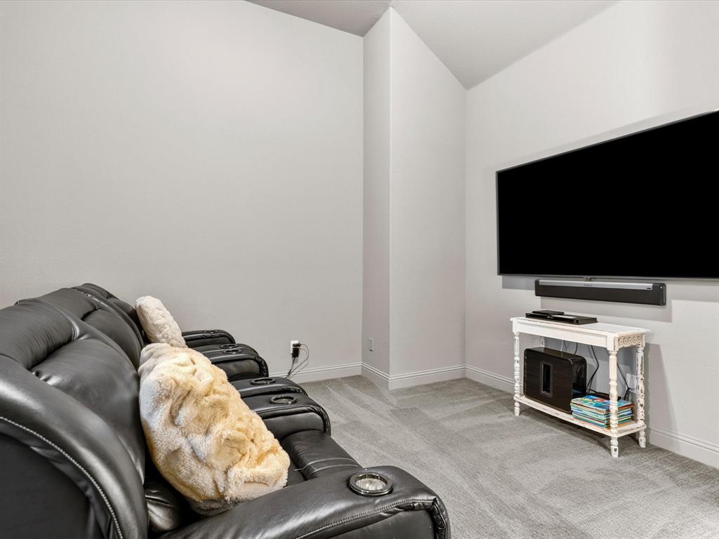 1630 Pebblebrook Lane Prosper, TX 75078 - Photo 11 of 40 a living room with furniture and a flat screen tv
