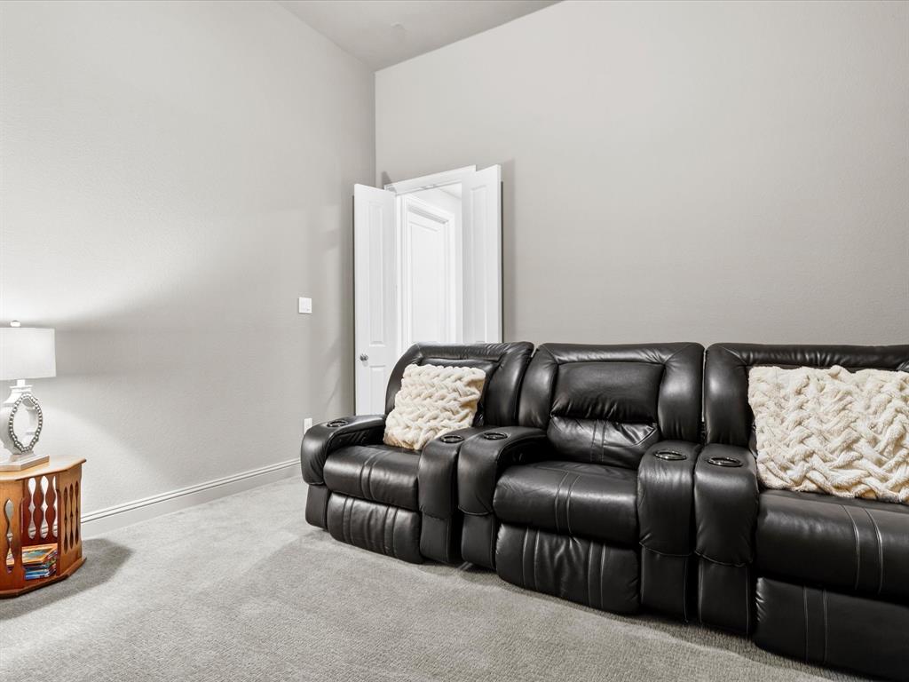 1630 Pebblebrook Lane Prosper, TX 75078 - Photo 12 of 40 a projector room with a couch