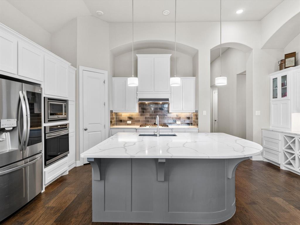 1630 Pebblebrook Lane Prosper, TX 75078 - Photo 16 of 40 a large kitchen with kitchen island a sink stainless steel appliances and cabinets