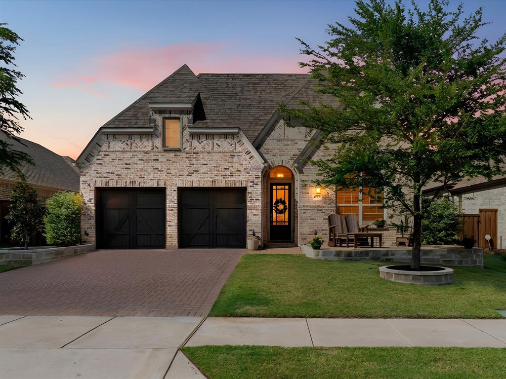 1630 Pebblebrook Lane Prosper, TX 75078 - Photo 2 of 40 a front view of a house with a garden and trees