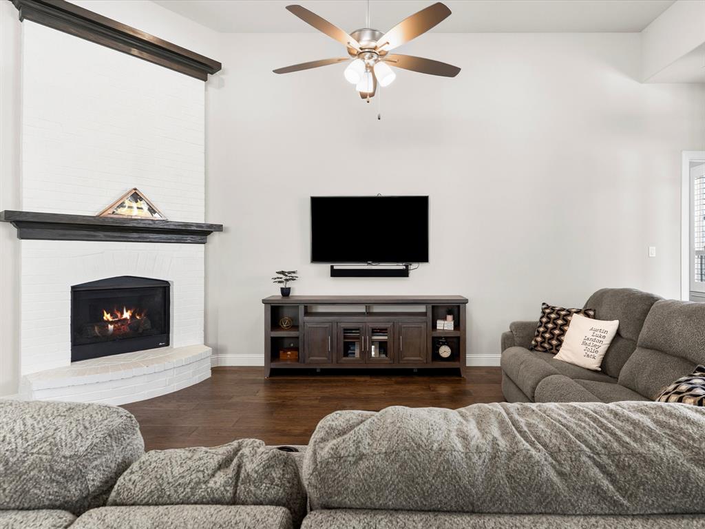1630 Pebblebrook Lane Prosper, TX 75078 - Photo 21 of 40 a living room with furniture and a fireplace