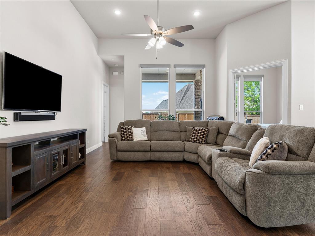 1630 Pebblebrook Lane Prosper, TX 75078 - Photo 22 of 40 a living room with furniture and a flat screen tv