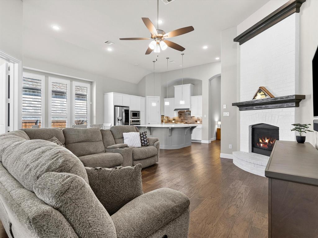 1630 Pebblebrook Lane Prosper, TX 75078 - Photo 23 of 40 a living room with furniture and a fireplace