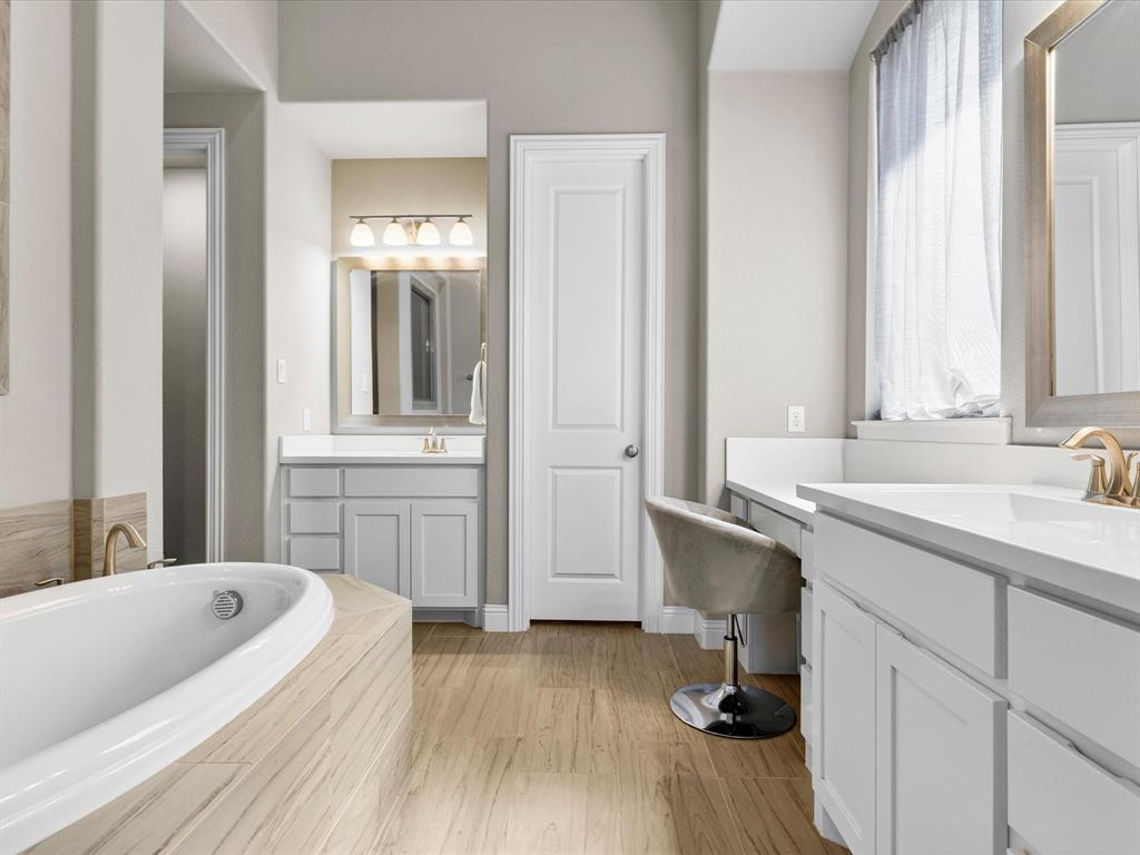 1630 Pebblebrook Lane Prosper, TX 75078 - Photo 28 of 40 a bathroom with a sink a bathtub and a window