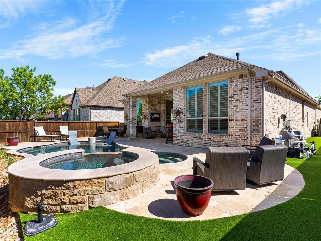 1630 Pebblebrook Lane Prosper, TX 75078 - Photo 34 of 40 a view of a house with backyard sitting area and swimming pool