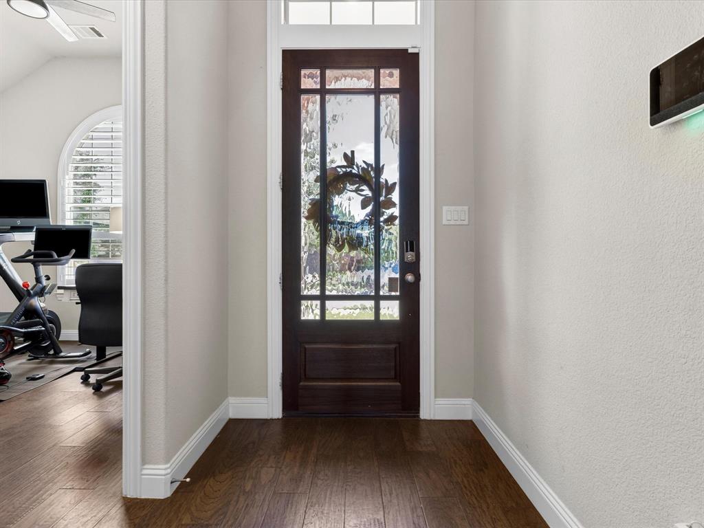 1630 Pebblebrook Lane Prosper, TX 75078 - Photo 6 of 40 a view of a hallway with wooden floor and windows
