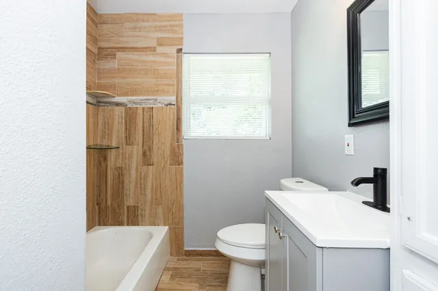 a bathroom with a sink toilet and shower