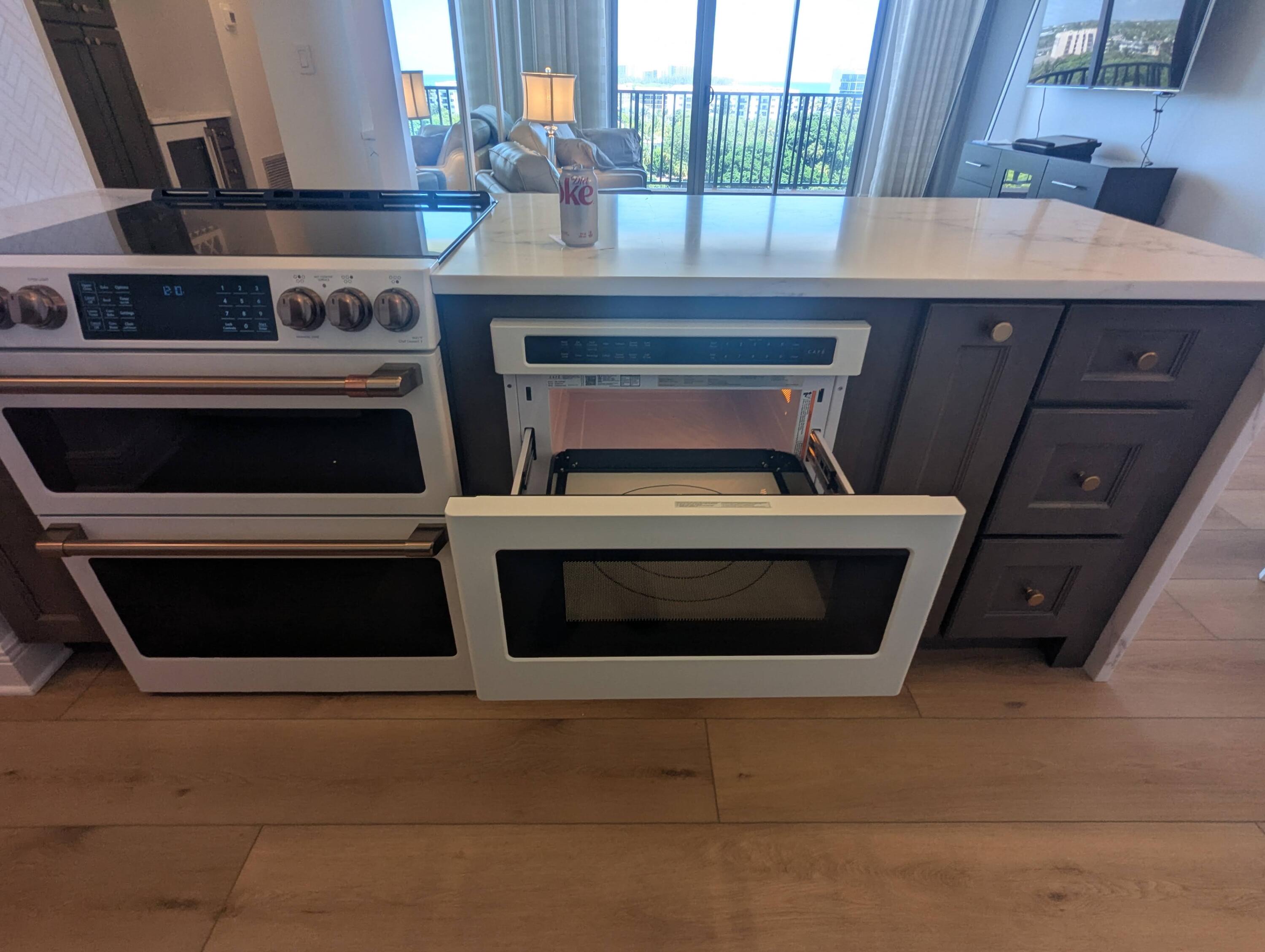 2121 North Ocean Boulevard, Unit 1006E Boca Raton, FL 33431 - Photo 29 of 64 a stove top oven sitting inside of a kitchen