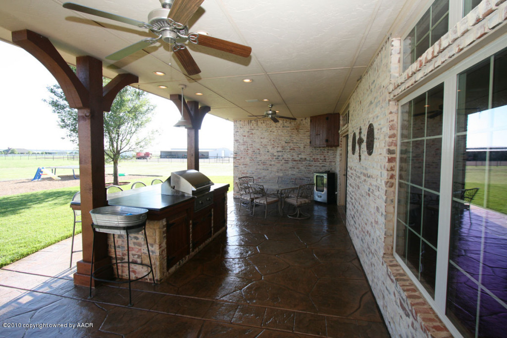 9000 Blackhawk Road Amarillo, TX 79119 - Photo 12 of 39 a living room with hardwood floor and a ceiling fan