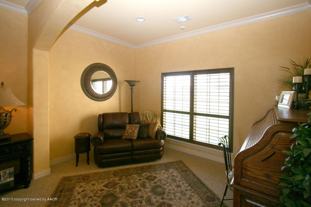 9000 Blackhawk Road Amarillo, TX 79119 - Photo 14 of 39 a living room with furniture a flat screen tv and a window