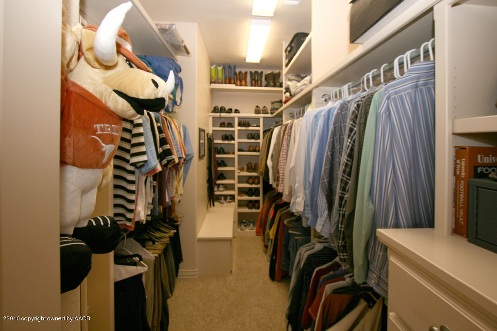 9000 Blackhawk Road Amarillo, TX 79119 - Photo 22 of 39 a view of walk in closet with clothes