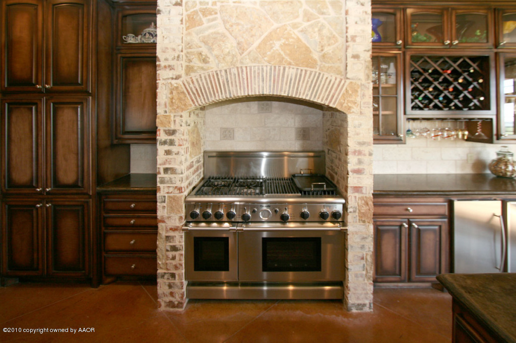 9000 Blackhawk Road Amarillo, TX 79119 - Photo 7 of 39 a kitchen with stove and cabinets