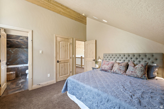 5404 Mountain View Road Coalville, UT 84017 - Photo 28 of 50 Angled ceiling with wood beam accent, light wood doors, and plush carpet flooring