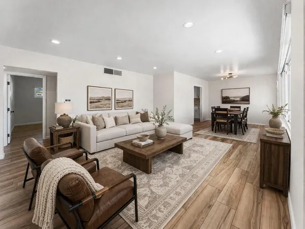 a living room with furniture and wooden floor