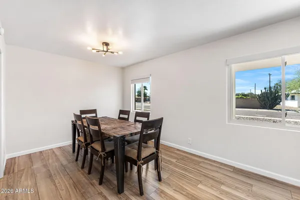 a view of a dining room with furniture window and wooden floor