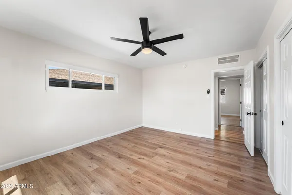 a view of empty room with wooden floor