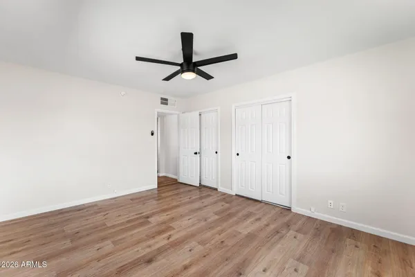 a view of a room with wooden floor and white walls