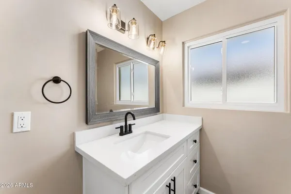 a bathroom with a sink and a mirror
