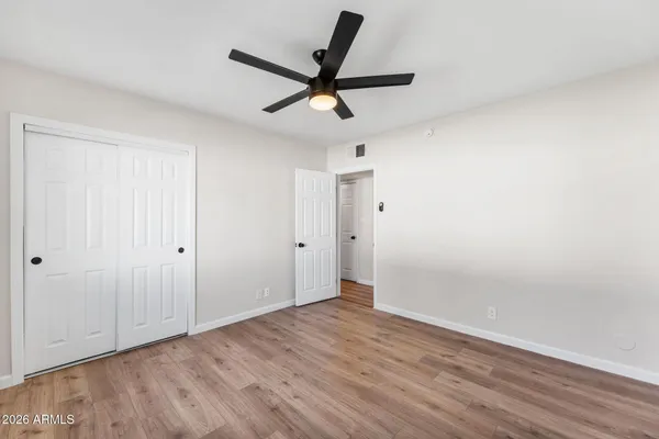a view of empty room with wooden floor