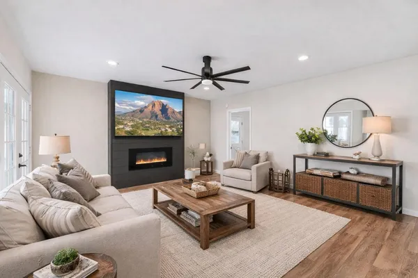 a living room with furniture a clock and a fireplace