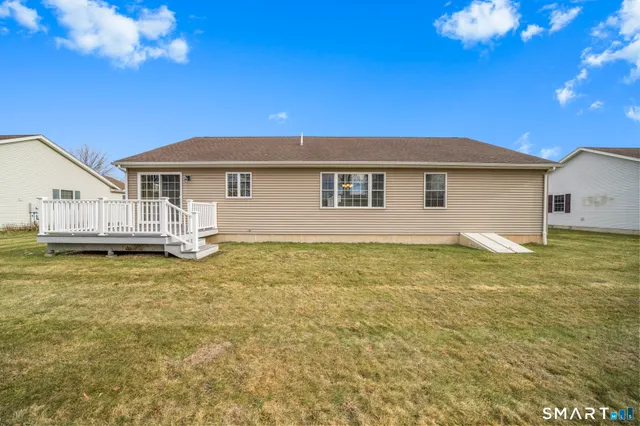 a view of a house with backyard and sitting area