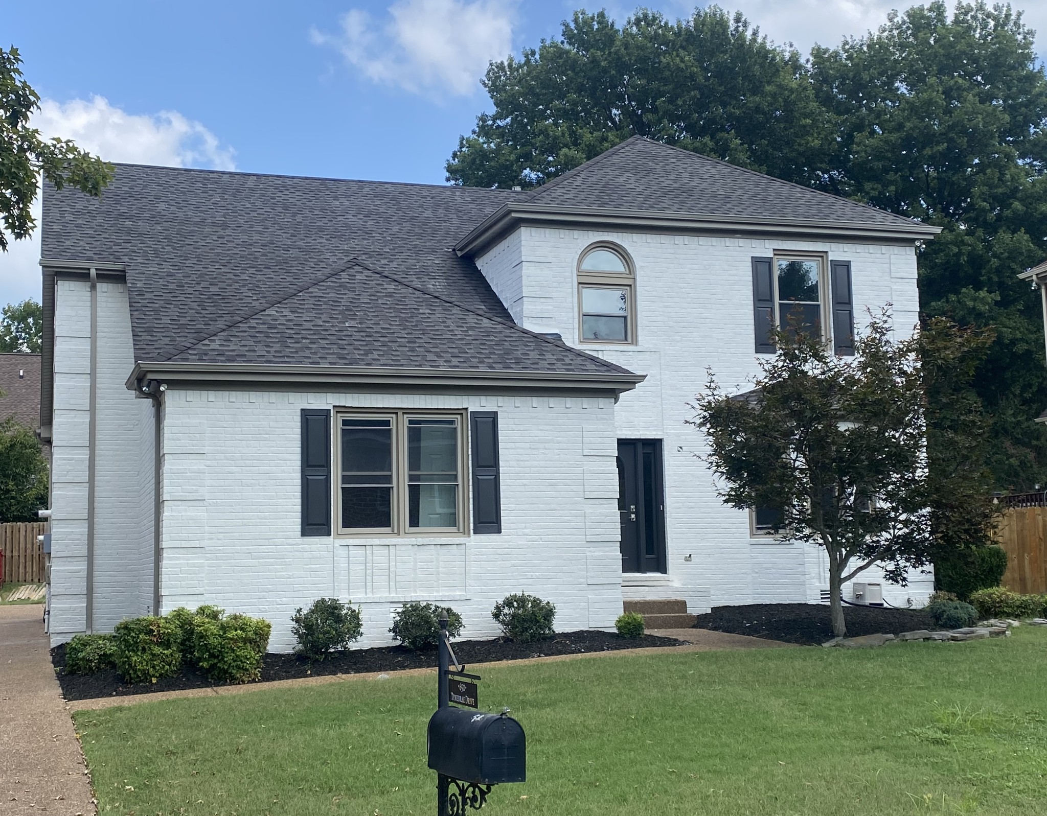 a front view of a house with a garden