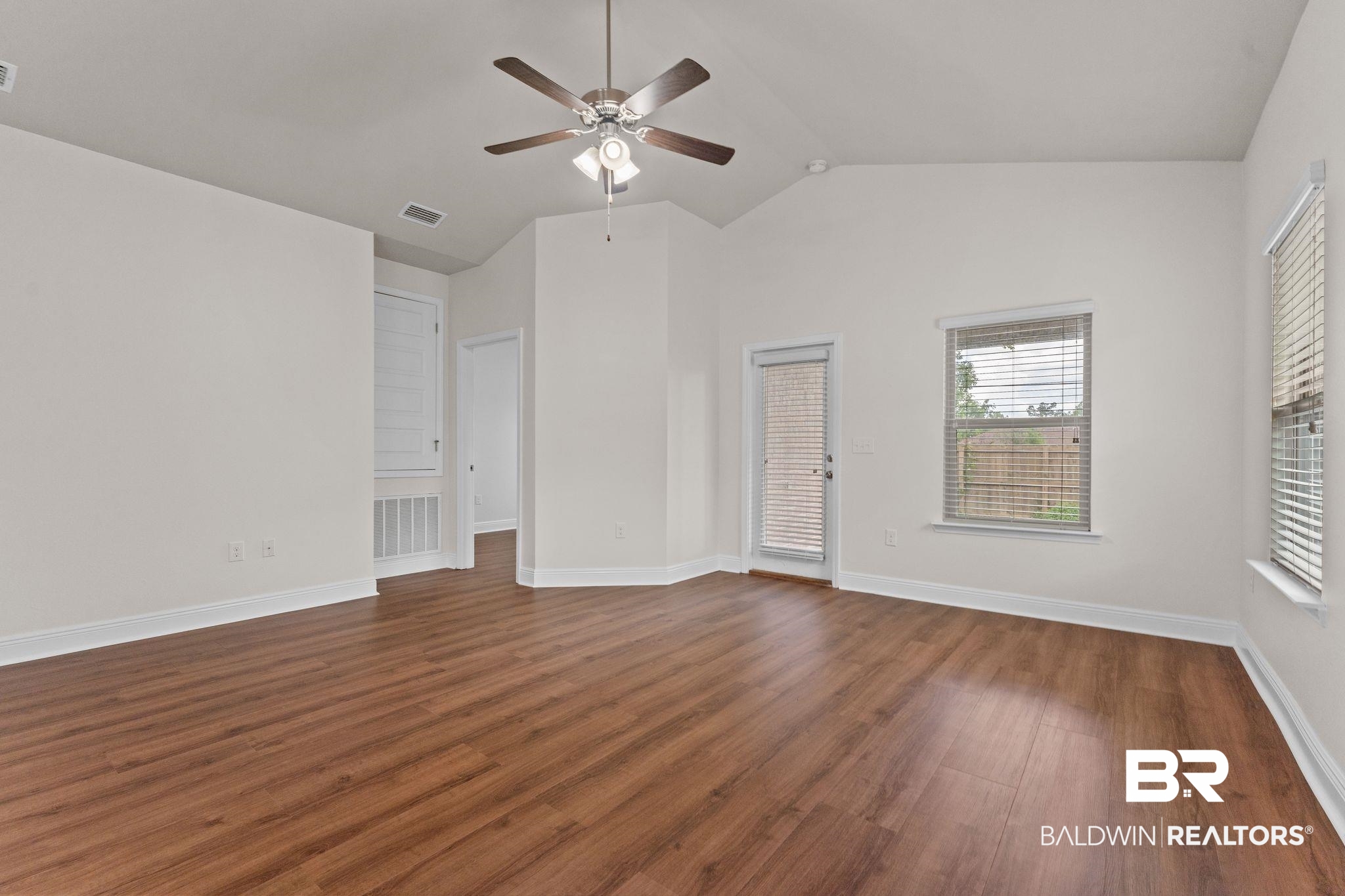 1464 Surrey Loop Foley, AL 36535 - Photo 8 of 24 Unfurnished living room with a ceiling fan, dark wood finished floors, and vaulted ceiling