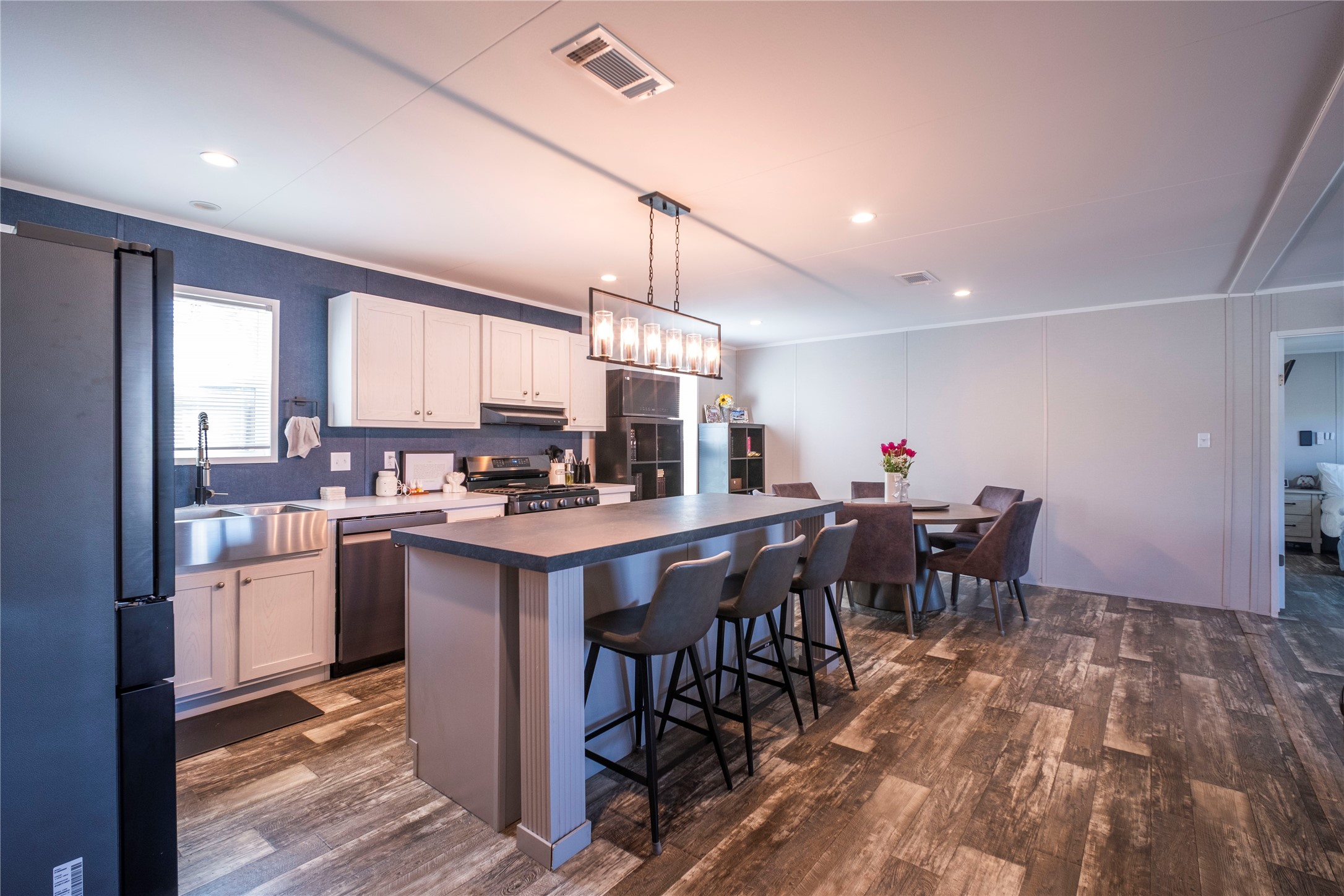 5402 Five Oaks Drive Spring, TX 77389 - Photo 7 of 20 a kitchen with stainless steel appliances kitchen island granite countertop a table chairs sink and cabinets