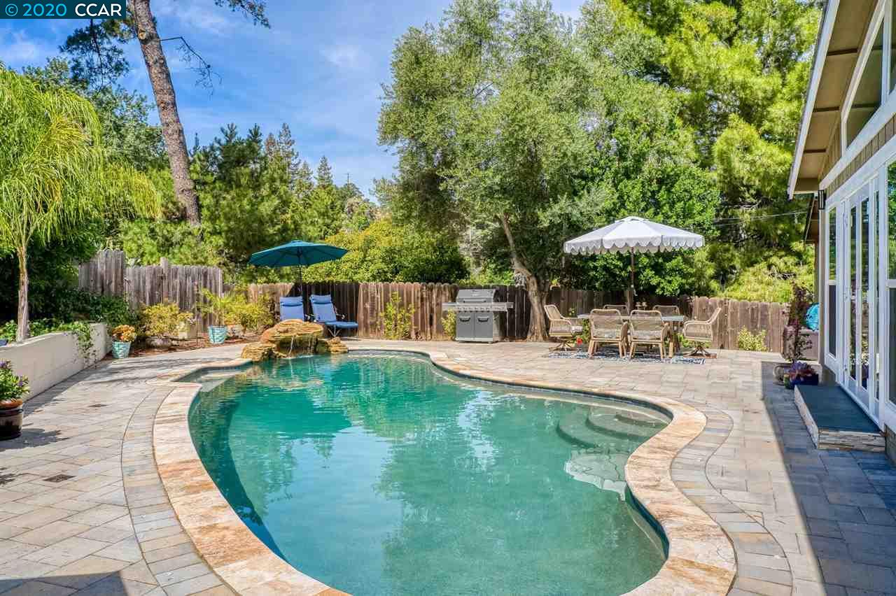 an outdoor space with swimming pool and furniture