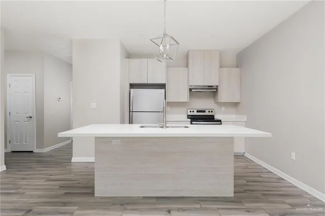 a view of kitchen with granite countertop wooden floor