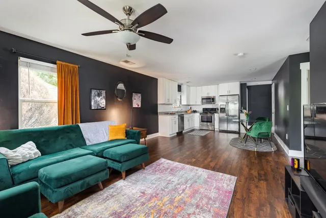 a living room with furniture and a wooden floor